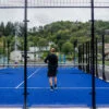 To menn som spiller utendørs padeltennis